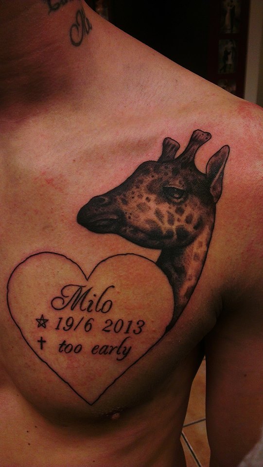 Giraffe tattoo with heart symbol on chest