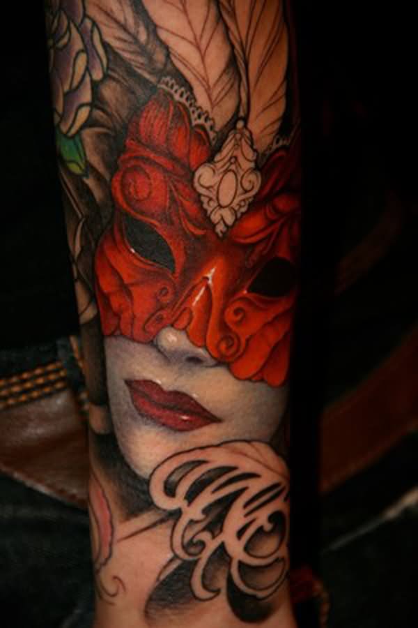 Girl with red mask tattoo on arm by Jeff Gogue