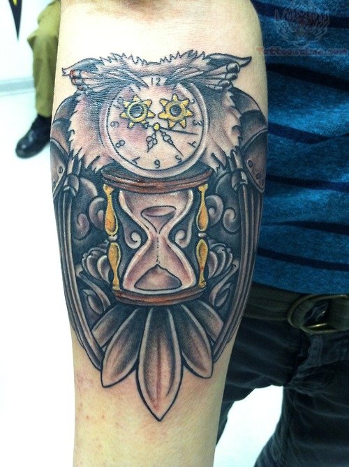 Amazing Hourglass And Clock In Owl Tattoo On Forearm