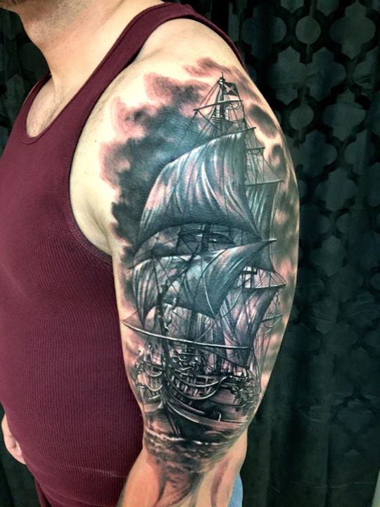 Amazing black sailor ship tattoo on sleeve by Carl Grace