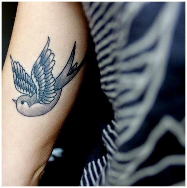 Awesome Black And Grey Flying Swallow Tattoo On Half Sleeve