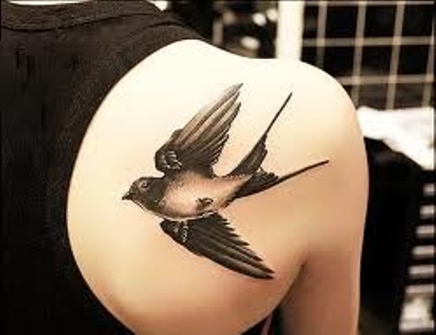 Awesome Black Flying Swallow Tattoo on Girl Back Shoulder