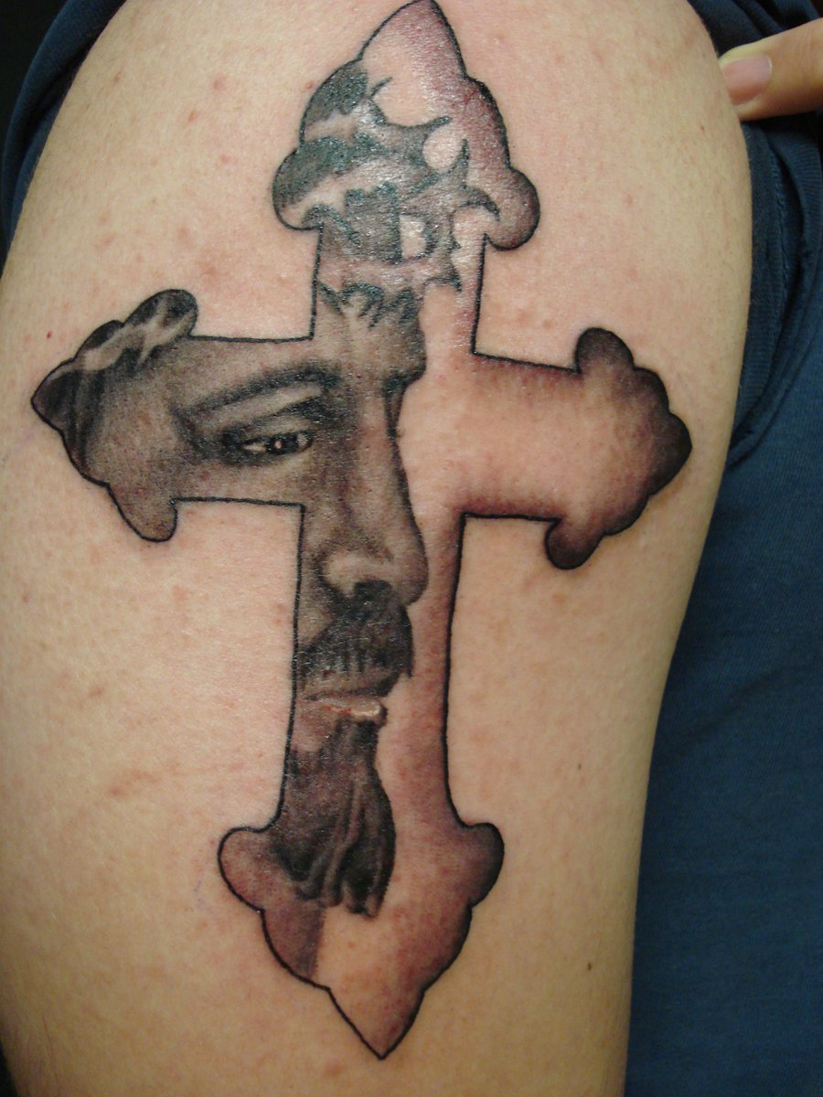Black And Grey 3D Jesus Face In Cross Tattoo On Shoulder