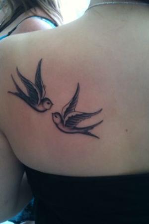 Black And Grey Flying Swallows Tattoo On Girl Back Shoulder
