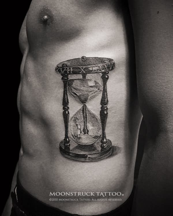 Black And Grey Hourglass Tattoo On Man Side Rib