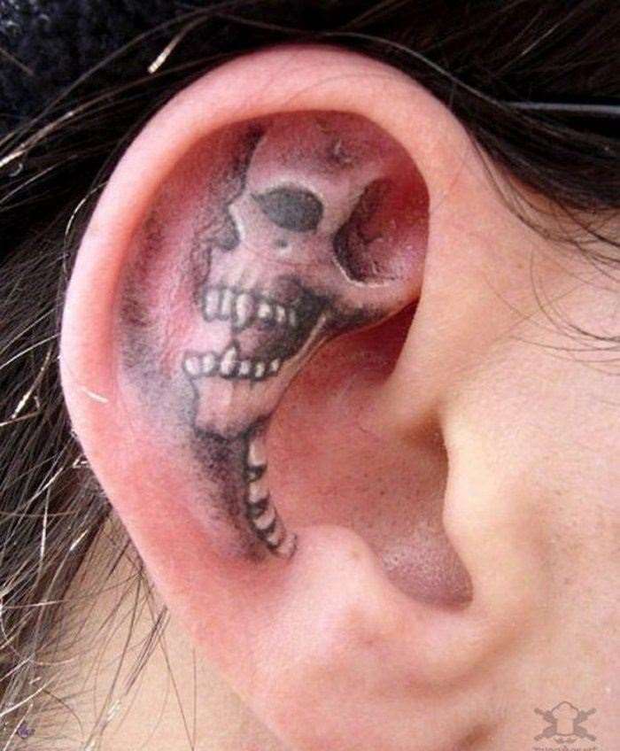 Black And Grey Skull Tattoo On Ear By Arcaneserpent