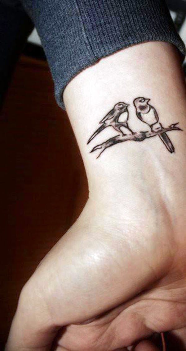 Black And Grey Two Swallows Sitting On Branch Tattoo On Wrist