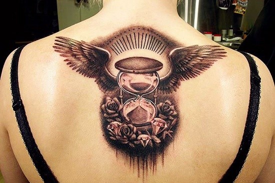 Black Hourglass With Wing And Flower Tattoo On Girl Back