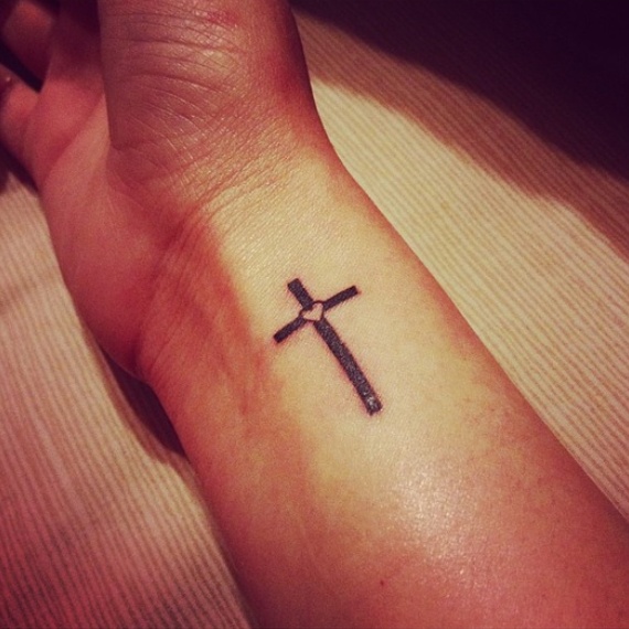 Black Little Heart In Cross Tattoo On Wrist