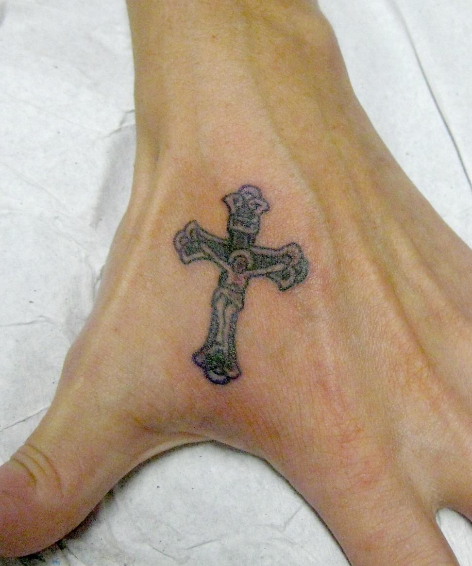 Black Small Crucified Jesus Cross Tattoo On Left Hand