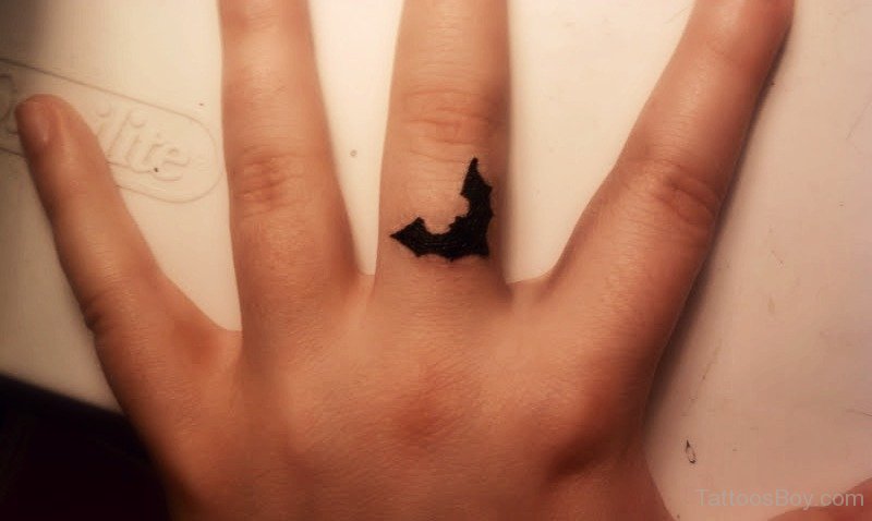 Black Tiny Bat Tattoo On Finger