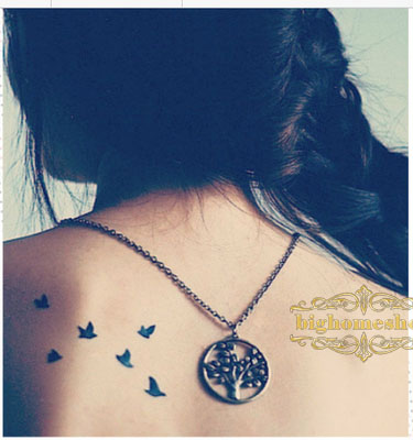 Black Tiny Flying Swallow Tattoo On Girl Upper Back Shoulder
