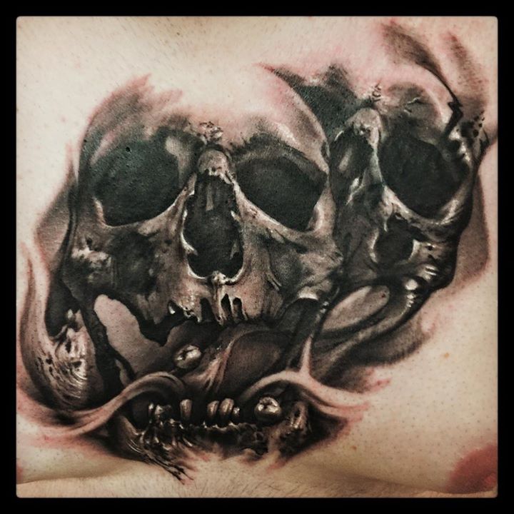 Black and grey skulls tattoo on chest