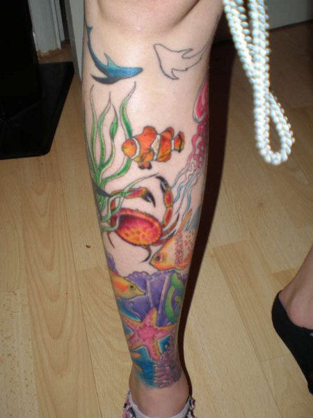 Colorful Fishes In Underwater Ocean Tattoo On Leg