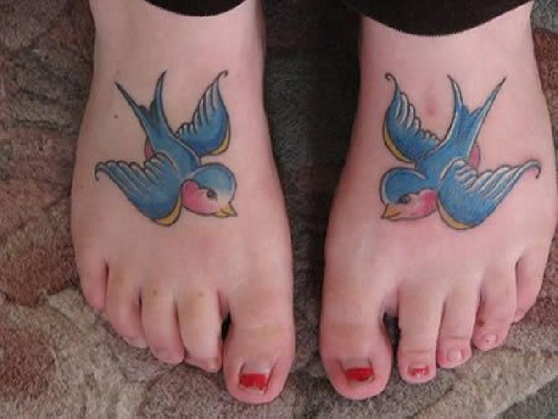 Colorful Flying Swallow Tattoo On Feet