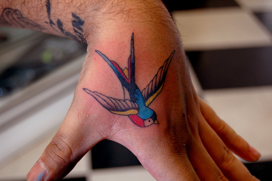 Colorful Flying Swallow Tattoo On Hand By VenomVyxen