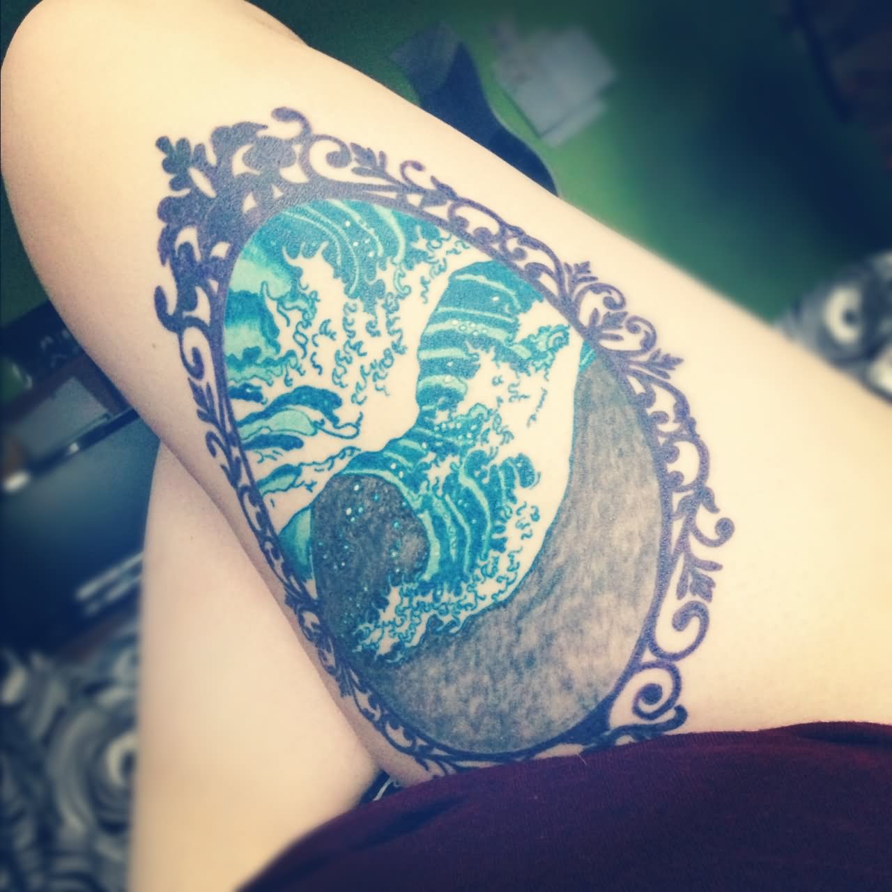 Colorful Ocean In Frame Tattoo On Girl Thigh