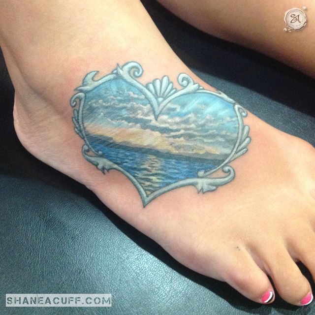 Colorful Ocean In Heart Frame Tattoo On Foot