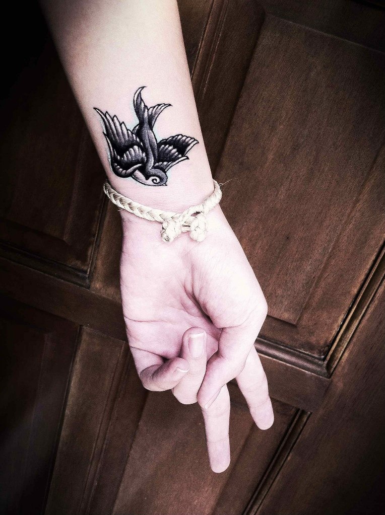 Cute Black And Grey Swallow Tattoo On Girl Wrist