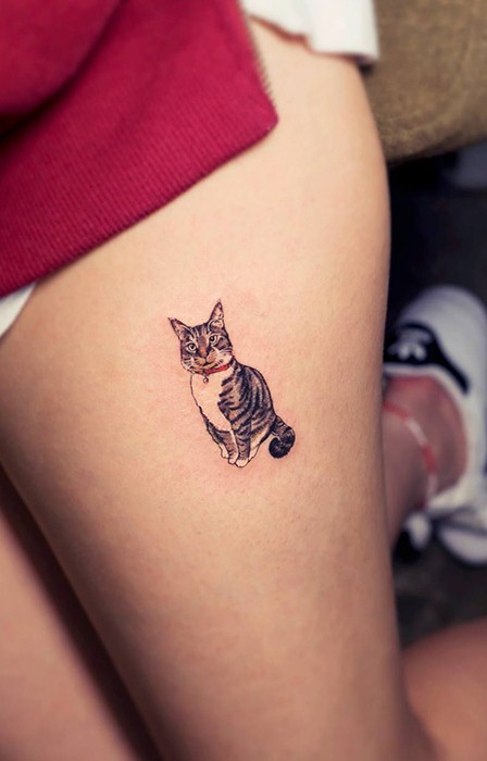 Cute Small Cat Tattoo On Girl’s Thigh