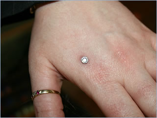 Dermal Anchor Single Point Piercing On Hand For Girls