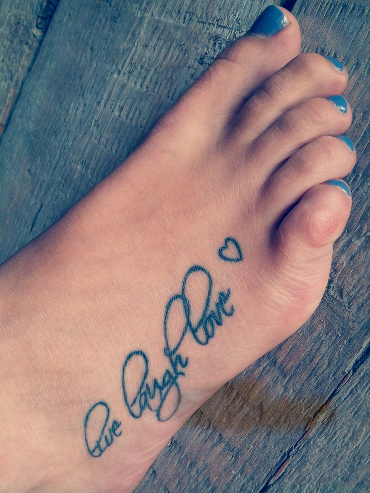 Girl Showing Her Live Laugh Love Tattoo On Foot