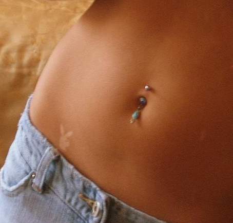 Hip Playboy Tattoo And Navel Piercing