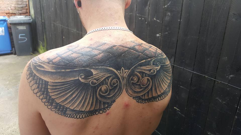 Nice Grey Ink Wings Tattoo On Man Upper Back