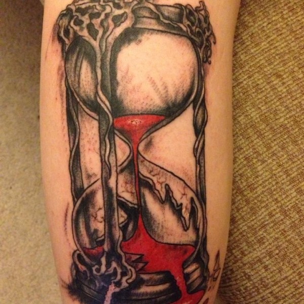 Red Sand In Black Hourglass Tattoo On Forearm