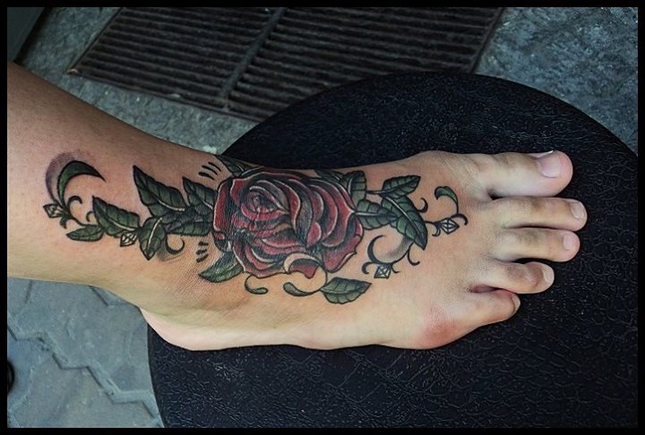 Red rose with leaves tattoo on foot by Salamandra