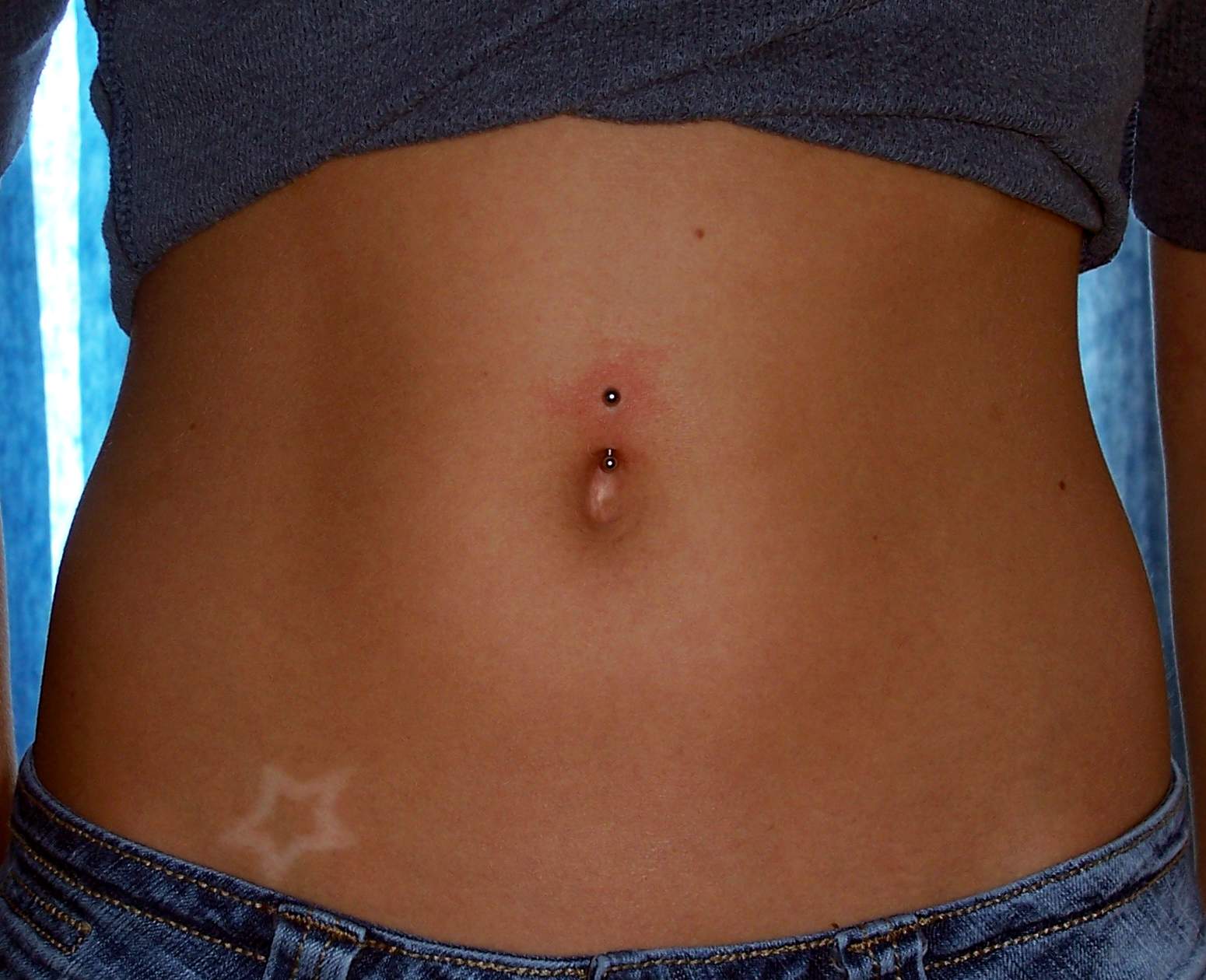 Star Hip Tattoo And Silver Barbell Navel Piercing