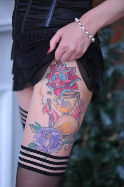 Watercolor Hourglass With Flowers Tattoo On Girl Thigh