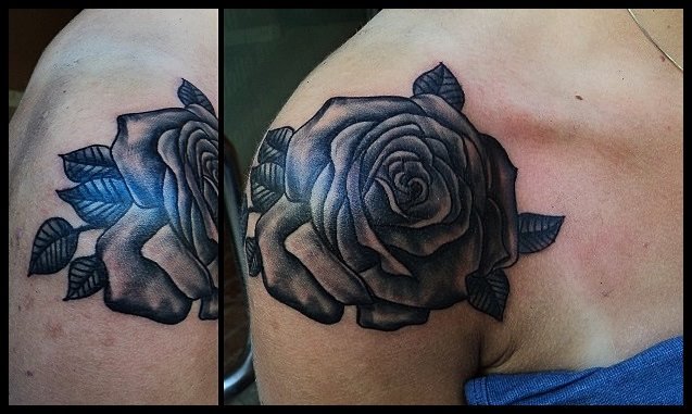 Wonderful black rose tattoo on shoulder by Salamandra