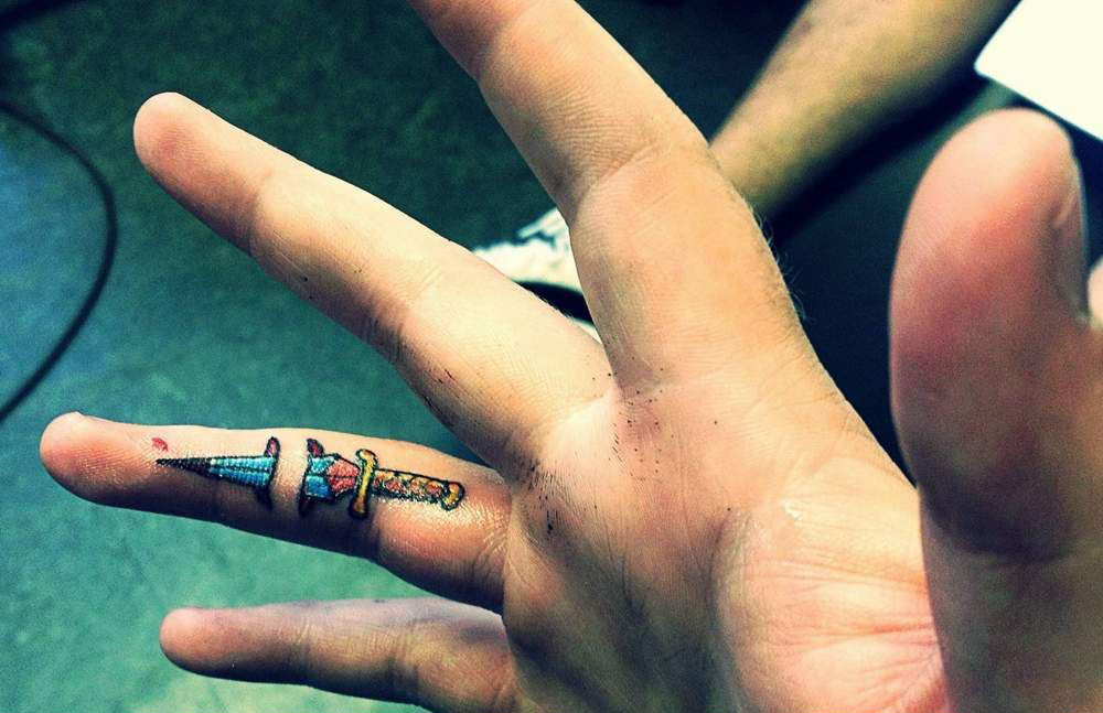 Amazing Colorful Dagger Tattoo On Finger