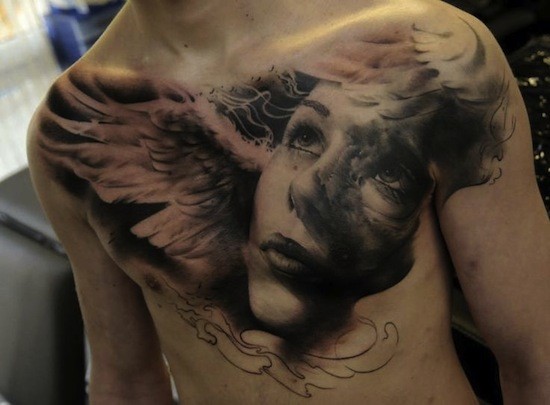 Black And Grey 3D Angel Face And Angel Wing Tattoo On Man Chest