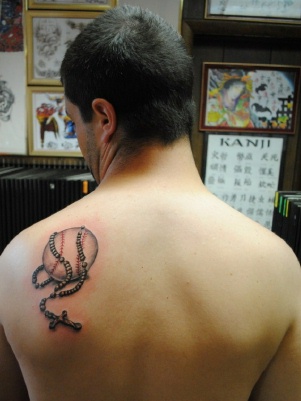 Black And Grey Baseball With Rosary Cross Tattoo On Man Left Back Shoulder