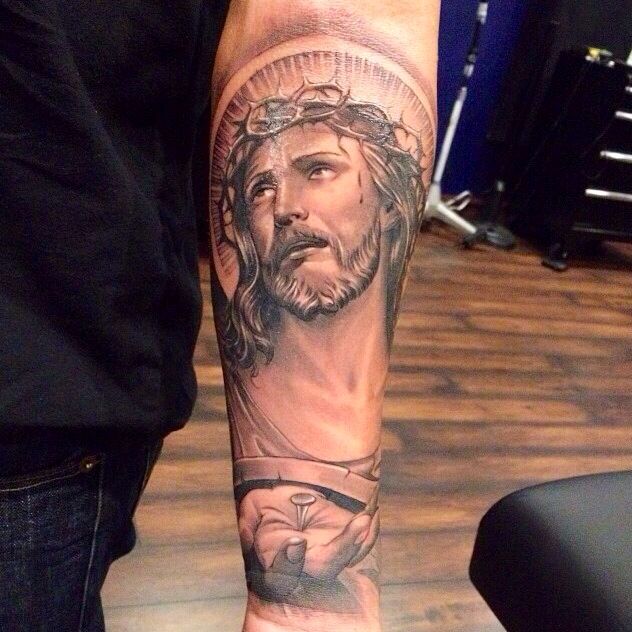 Black And Grey Jesus Face Tattoo On Forearm