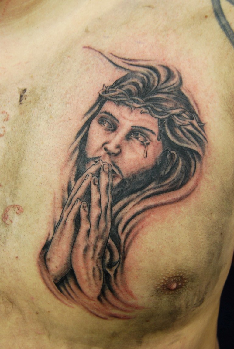 Black And Grey Jesus Praying Tattoo On Man Chest