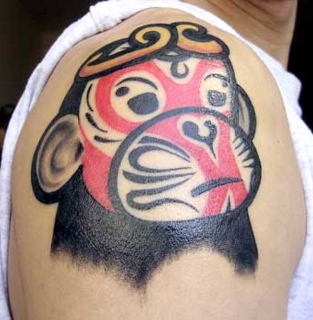 Black And Red Monkey Face Tattoo On Shoulder