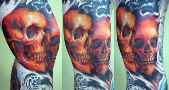 Black And Red Two Skulls Tattoo On Knee