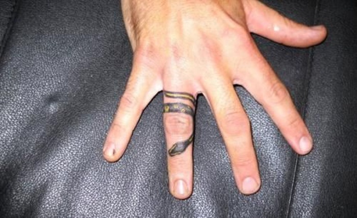Black And Yellow Snake Tattoo On Finger