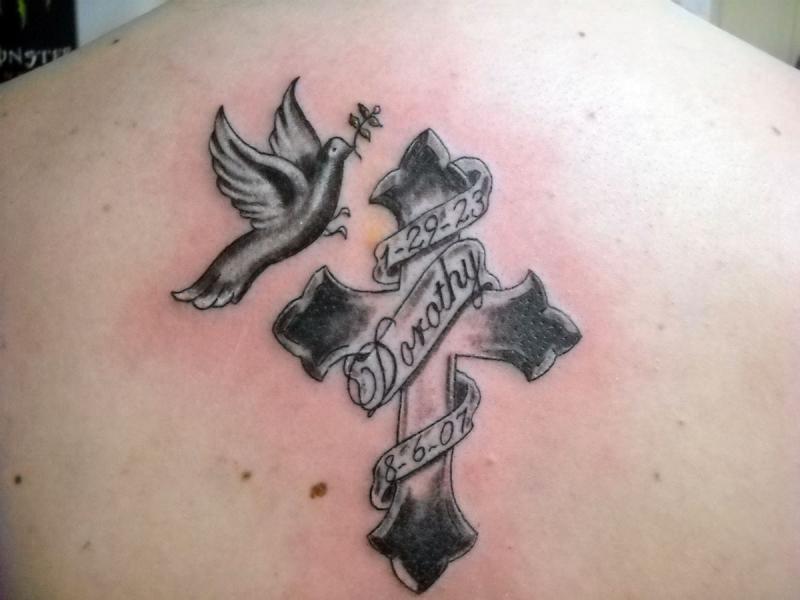 Black Dove With Cross And Banner Tattoo On Upper Back