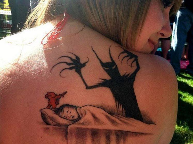 Black Ghost And Sleeping Baby Tattoo On Girl Upper Back