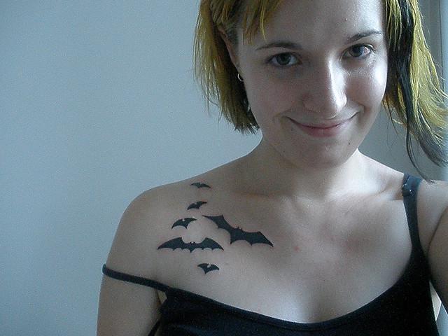 Black Little Flying Bats Tattoo On Girl Front Shoulder