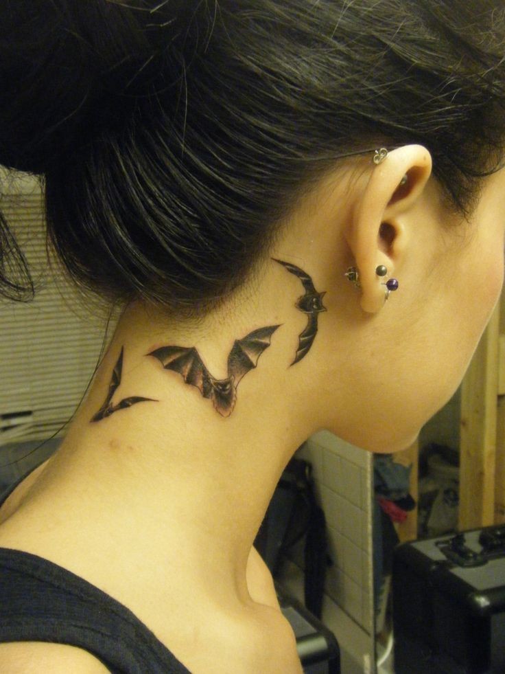 Black Three Flying Bats Tattoo On Girl Behind The Ear