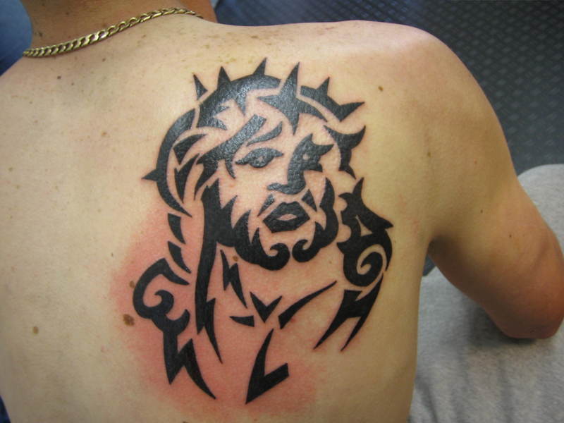 Black Tribal Jesus Tattoo On Man Back