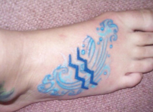 Blue Ink Aquarius Tattoo On Right Foot