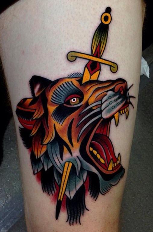 Colorful Dagger In Lion Face Tattoo On Thigh