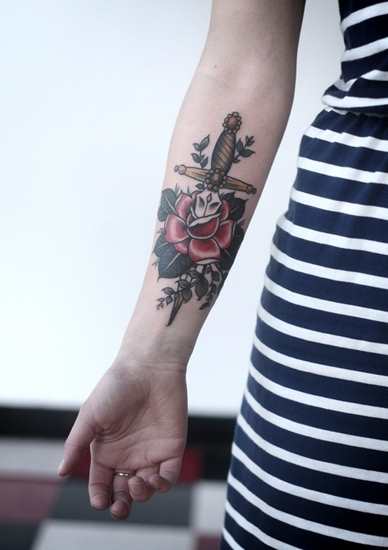 Colorful Dagger In Rose Tattoo On Girl Forearm By Alice Carrier