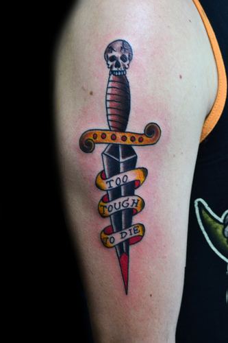 Colorful Dagger With Banner Tattoo On Man Shoulder